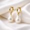 Amara Earrings- baroque pearls suspended from classic hoop in sterling silver with a gold-plated finish