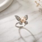 Kipepeo Ring- luminous peach freshwater pearl with cubic zirconia wings in sterling silver