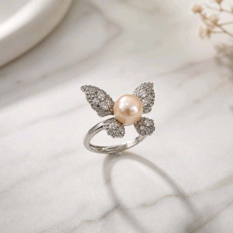 Kipepeo Ring- luminous peach freshwater pearl with cubic zirconia wings in sterling silver